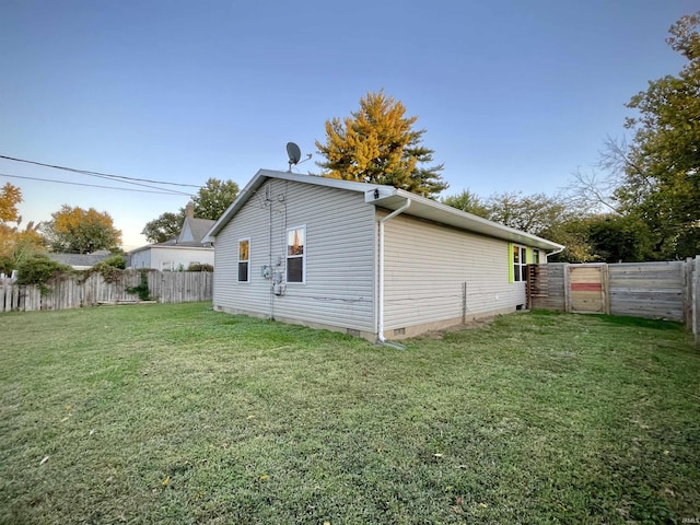 view of home's exterior featuring a fenced backyard, a yard, and crawl space