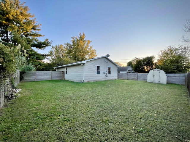 exterior space featuring a fenced backyard, an outbuilding, and a storage shed