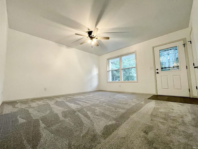 interior space with baseboards and a ceiling fan