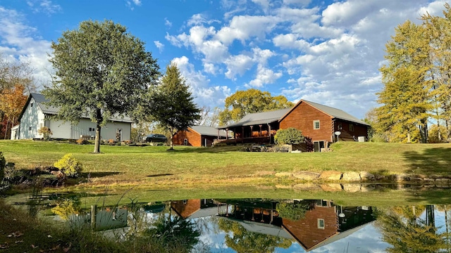 view of yard featuring a water view and a boat dock