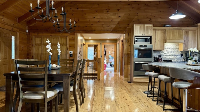15597 Buck Knob Ln, Loogootee, IN 47553 - dining space with wooden walls, light wood finished floors, a chandelier, and wood ceiling