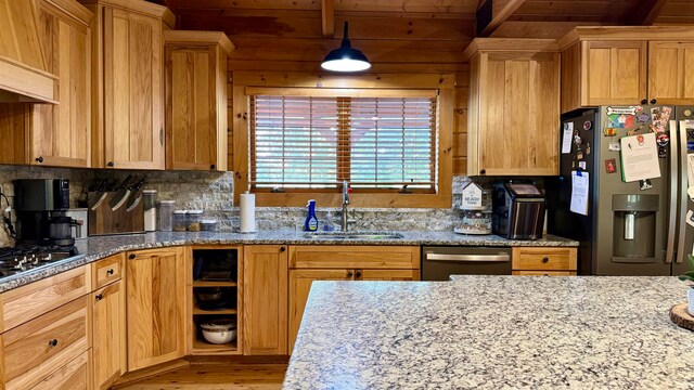 kitchen with custom exhaust hood, appliances with stainless steel finishes, light hardwood / wood-style flooring, sink, and decorative light fixtures