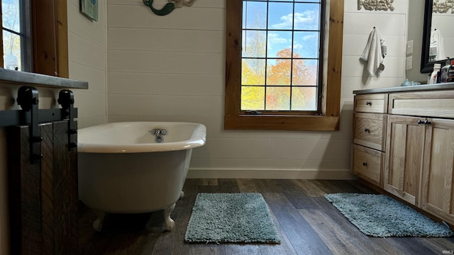15597 Buck Knob Ln, Loogootee, IN 47553 - bathroom featuring a freestanding tub, vanity, and wood finished floors