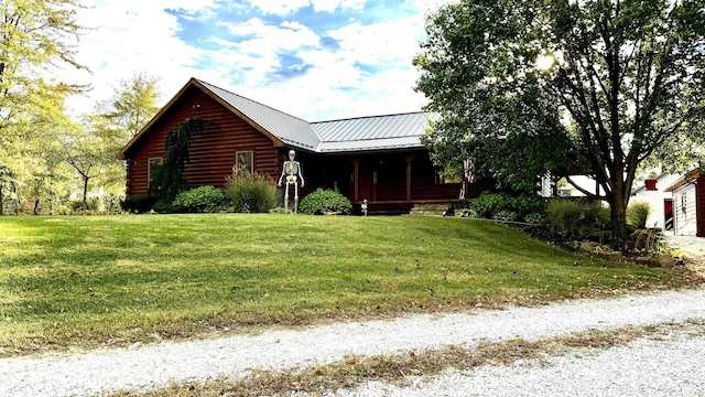 15597 Buck Knob Ln, Loogootee, IN 47553 - view of front of home featuring a front lawn, a metal roof, covered porch, and log siding