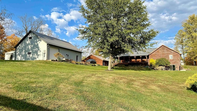 view of yard featuring an outdoor structure and a garage