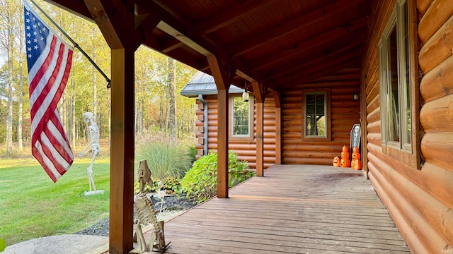 wooden terrace with a lawn