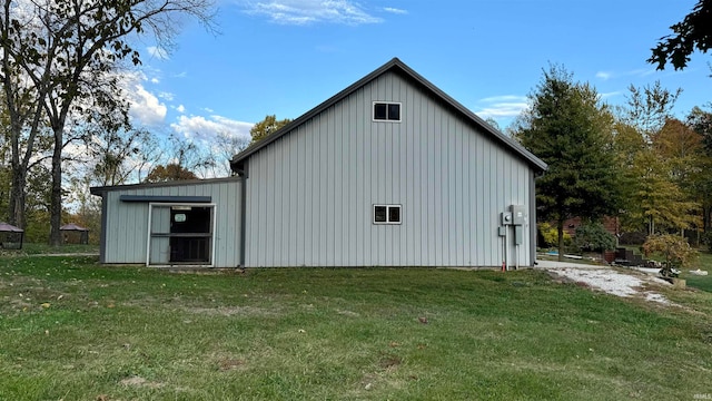 view of home's exterior featuring a lawn and an outdoor structure