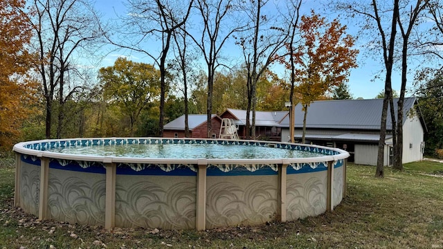 view of swimming pool featuring a yard