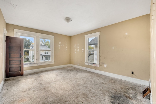 empty room with carpet flooring and plenty of natural light