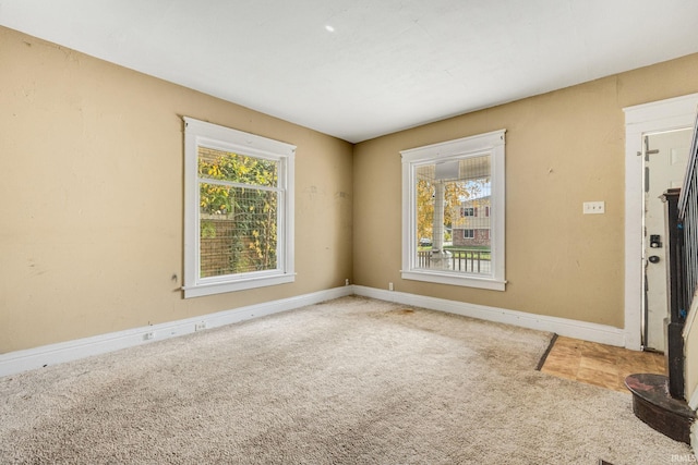 carpeted spare room featuring a wealth of natural light