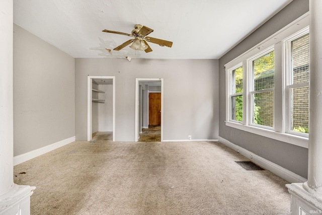 unfurnished bedroom featuring carpet and ceiling fan