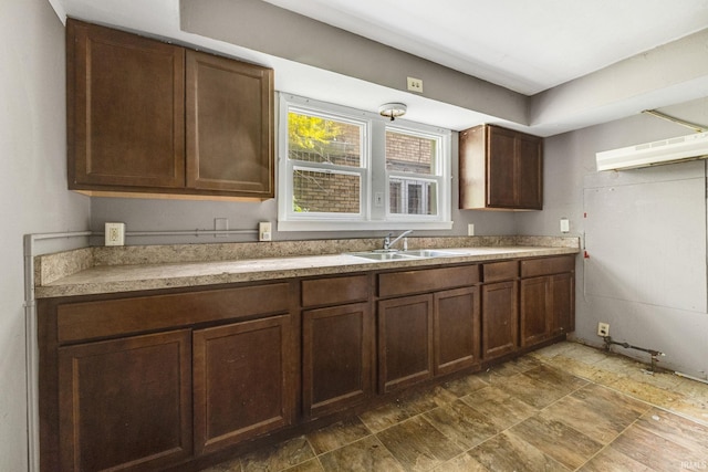 kitchen with dark brown cabinetry and sink