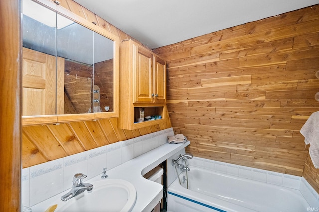 bathroom with wood walls and sink