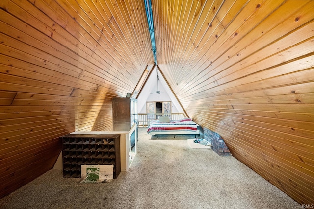 unfurnished bedroom featuring lofted ceiling, carpet floors, wooden walls, and wooden ceiling