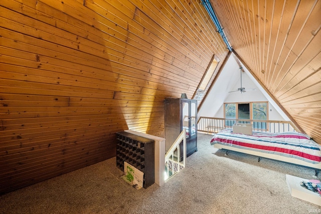 unfurnished bedroom featuring wooden ceiling, carpet flooring, vaulted ceiling, and wooden walls