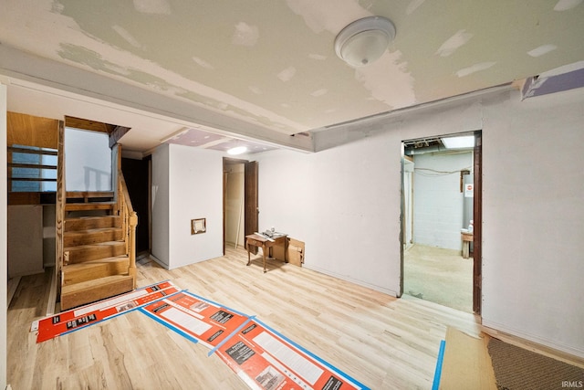 basement with light hardwood / wood-style floors