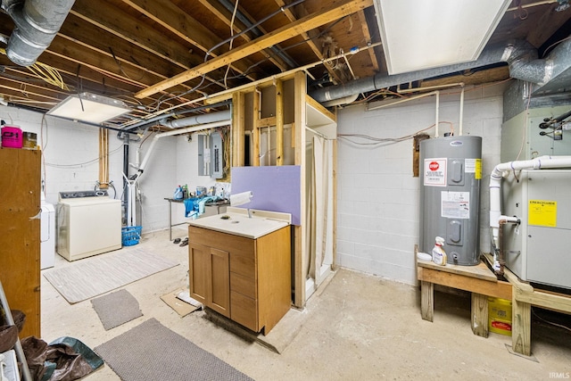 basement featuring electric water heater, electric panel, heating unit, and washing machine and clothes dryer