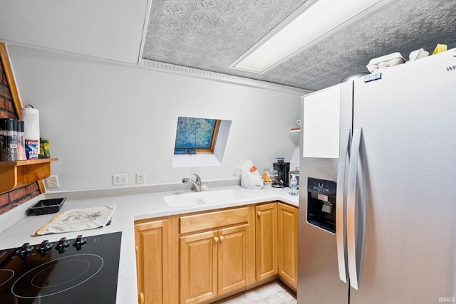 kitchen featuring sink, cooktop, a textured ceiling, and stainless steel fridge with ice dispenser