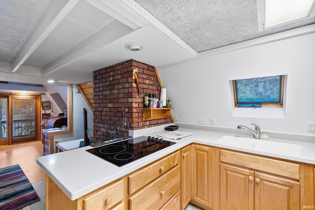 kitchen featuring sink, light wood-type flooring, black electric cooktop, kitchen peninsula, and light brown cabinets