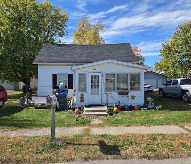 bungalow-style house with a front lawn