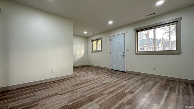 empty room featuring hardwood / wood-style flooring and plenty of natural light