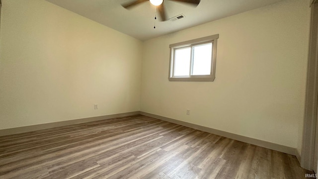 spare room featuring wood-type flooring and ceiling fan