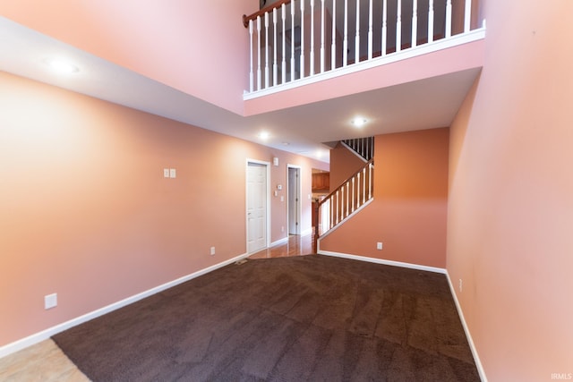 interior space with a towering ceiling and carpet