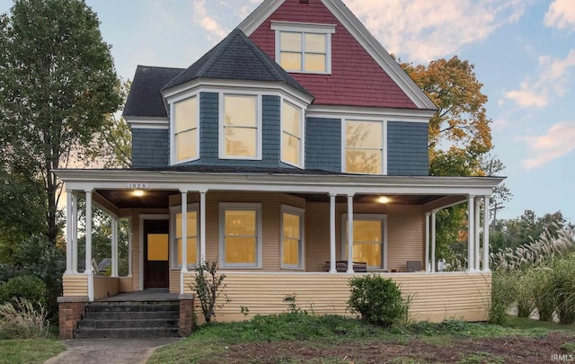 1025 W Lincolnway, Mishawaka, IN 46545 - victorian home featuring a porch and roof with shingles