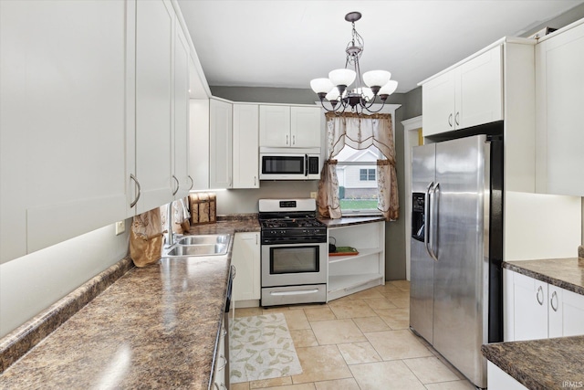 1025 W Lincolnway, Mishawaka, IN 46545 - kitchen featuring dark countertops, a sink, an inviting chandelier, stainless steel appliances, and white cabinetry