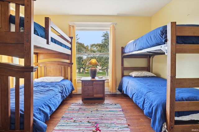 bedroom with dark hardwood / wood-style floors