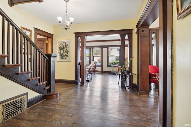 foyer with dark hardwood / wood-style flooring and a chandelier