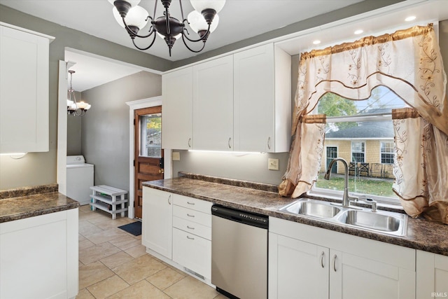 kitchen featuring washer / dryer, stainless steel dishwasher, sink, and plenty of natural light