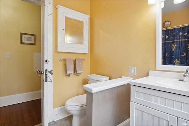 bathroom featuring vanity, toilet, and hardwood / wood-style flooring