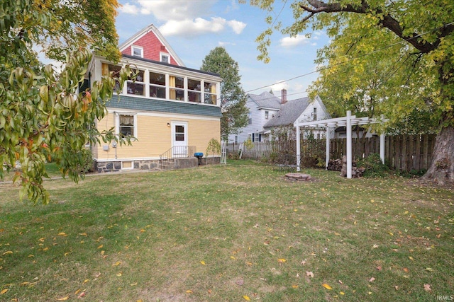 back of house with a patio, a yard, and a pergola