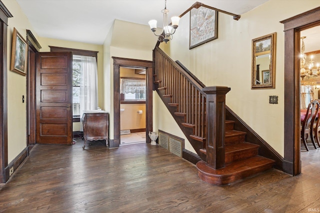 1025 W Lincolnway, Mishawaka, IN 46545 - staircase with an inviting chandelier, baseboards, and wood finished floors