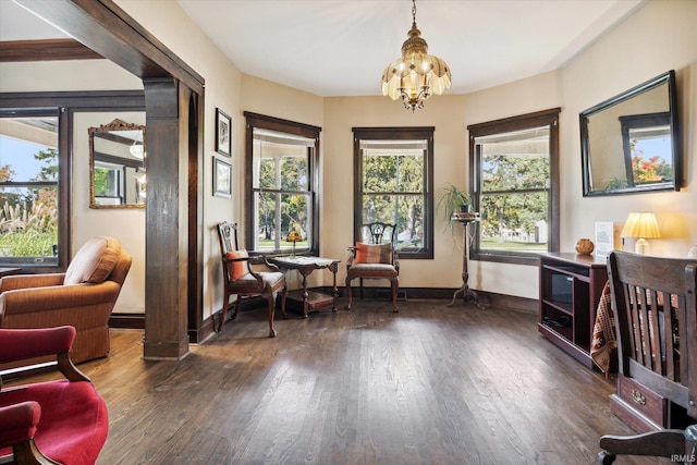 sitting room featuring dark hardwood / wood-style flooring, plenty of natural light, and an inviting chandelier