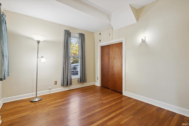 unfurnished bedroom with hardwood / wood-style floors