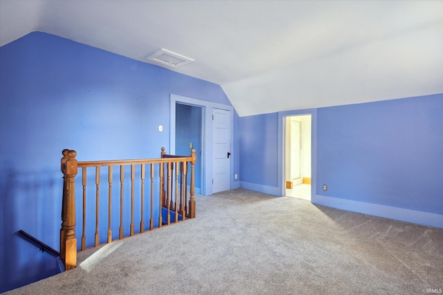 additional living space featuring carpet and lofted ceiling