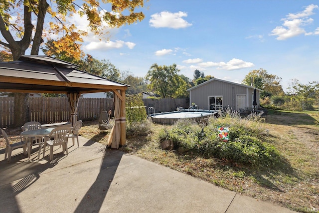 view of yard with a patio, a fenced in pool, and a gazebo