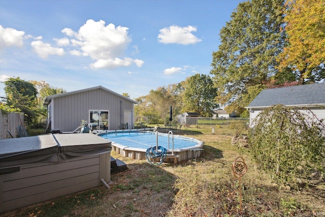 view of pool featuring a hot tub and a lawn