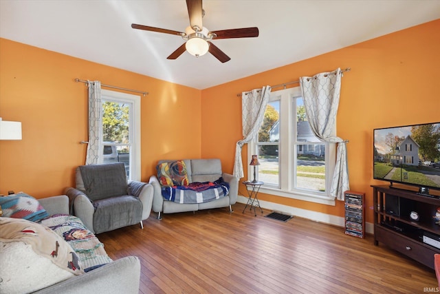 living room featuring hardwood / wood-style flooring and ceiling fan