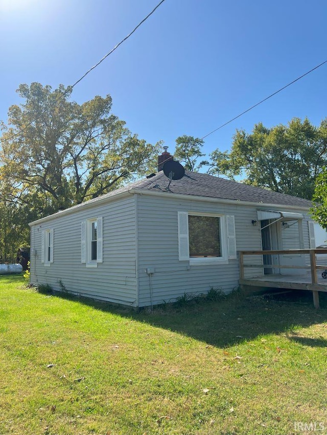 view of property exterior with a yard