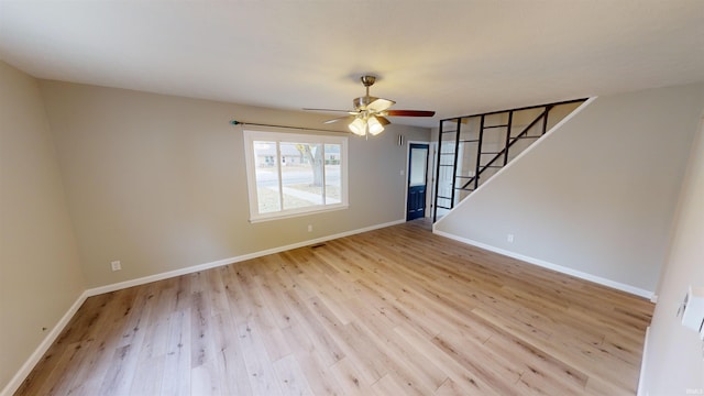 spare room with light wood-type flooring and ceiling fan