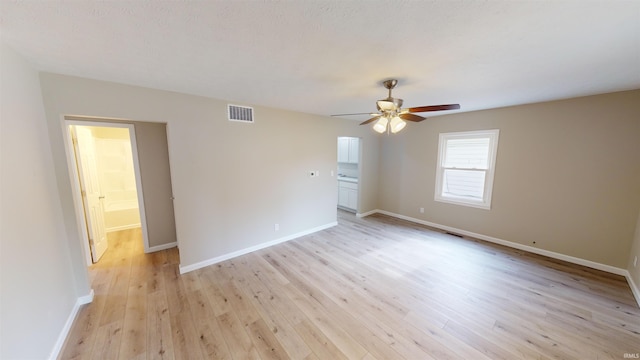 empty room with light hardwood / wood-style flooring and ceiling fan