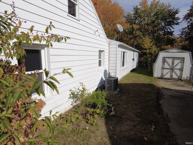 view of side of home with a storage shed and cooling unit