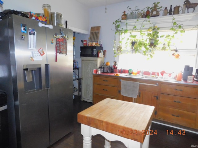 kitchen featuring sink and stainless steel fridge with ice dispenser