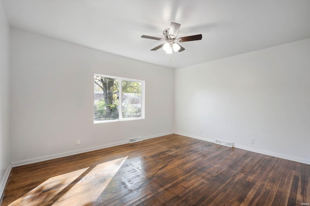 empty room with dark wood-type flooring and ceiling fan