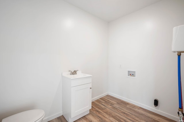 washroom featuring hookup for a washing machine, light hardwood / wood-style floors, and sink