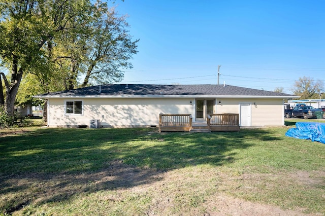 rear view of house featuring a yard and a wooden deck