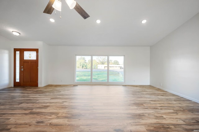 unfurnished living room featuring light hardwood / wood-style floors, lofted ceiling, and ceiling fan